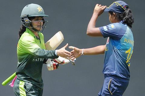 Javeria-Khan-is-congratulated-by-a-Sri-Lankan-player-after-reaching-her-century