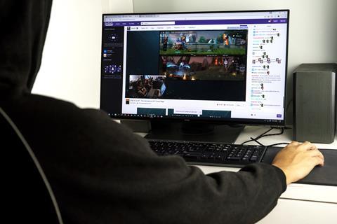 Man watching esports on Twitch credit Jasni Shutterstock