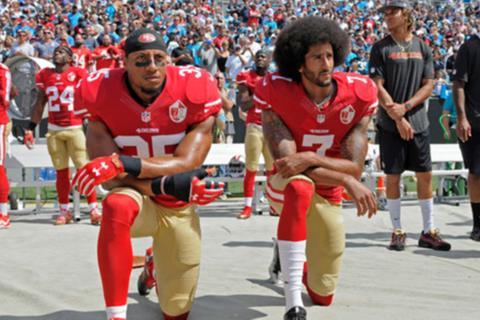 Colin Kaepernick (r) caused controversy when he began to kneel in protest for the national anthem