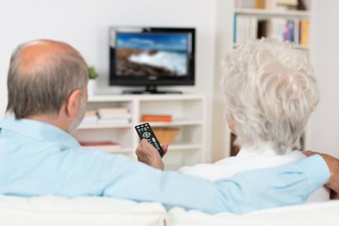 elderly couple watch tv